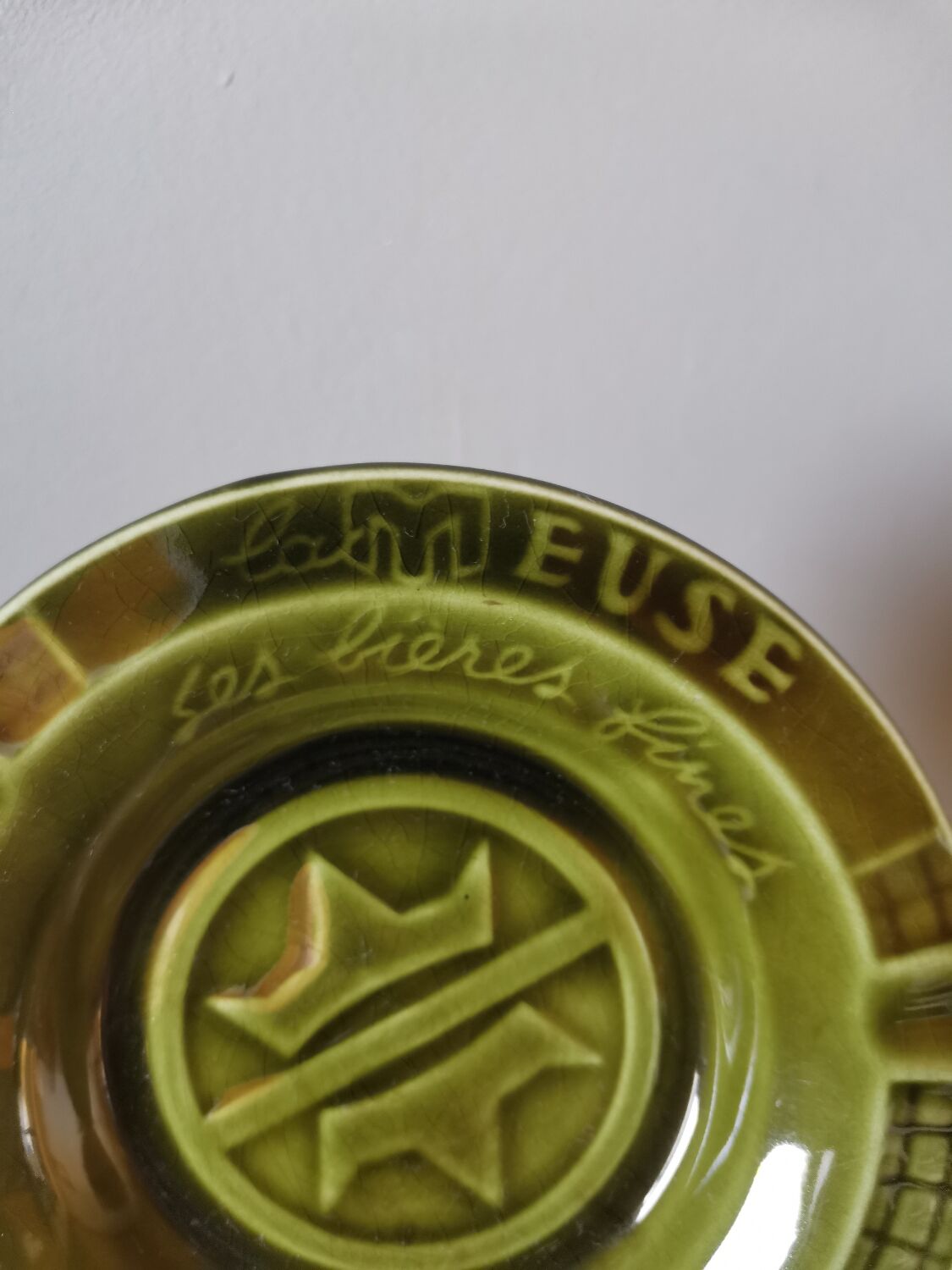 Green advertising ashtray in vintage slip from the Meuse its fine beers