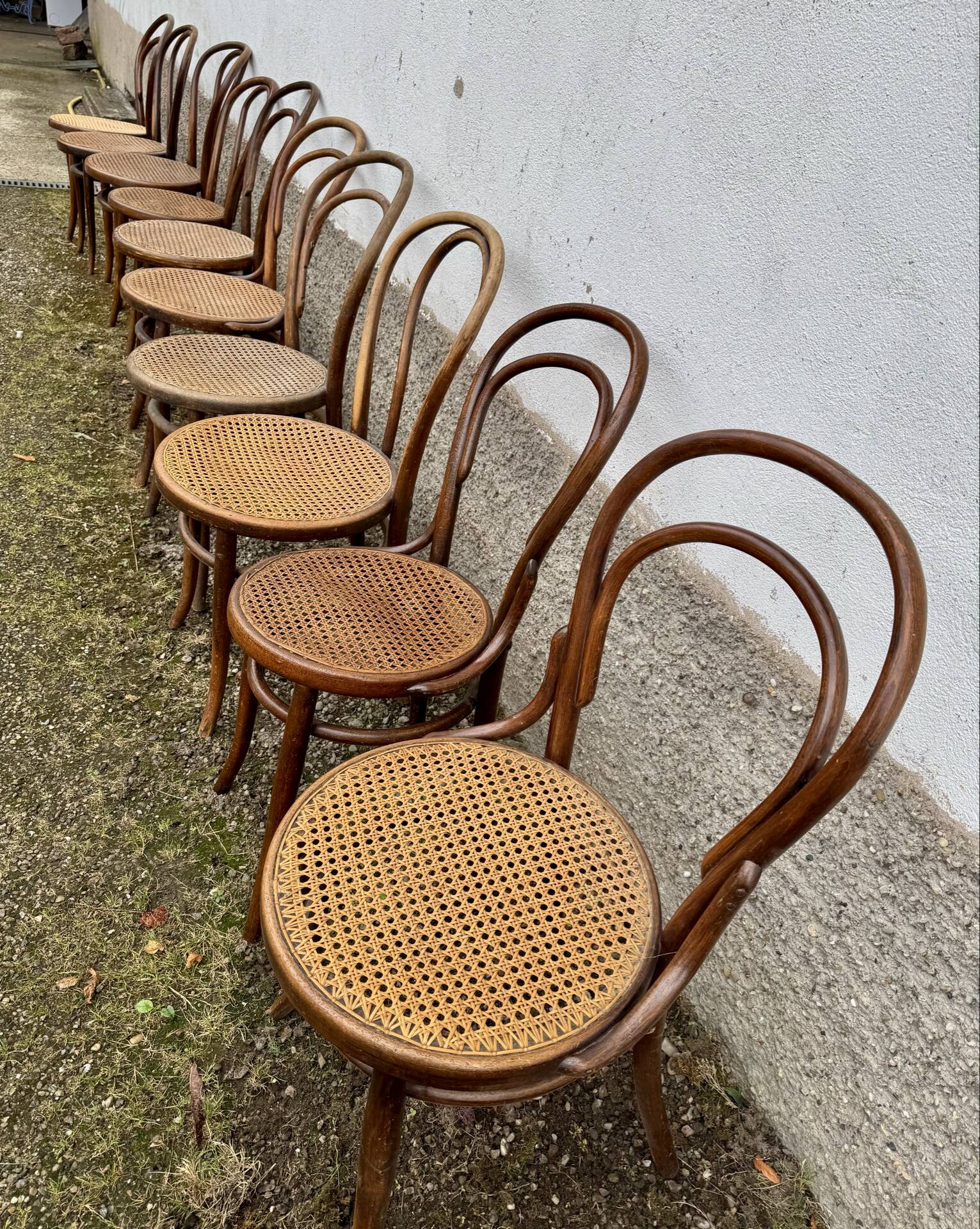 Set of 10 bentwood bistro chairs with cane seat.