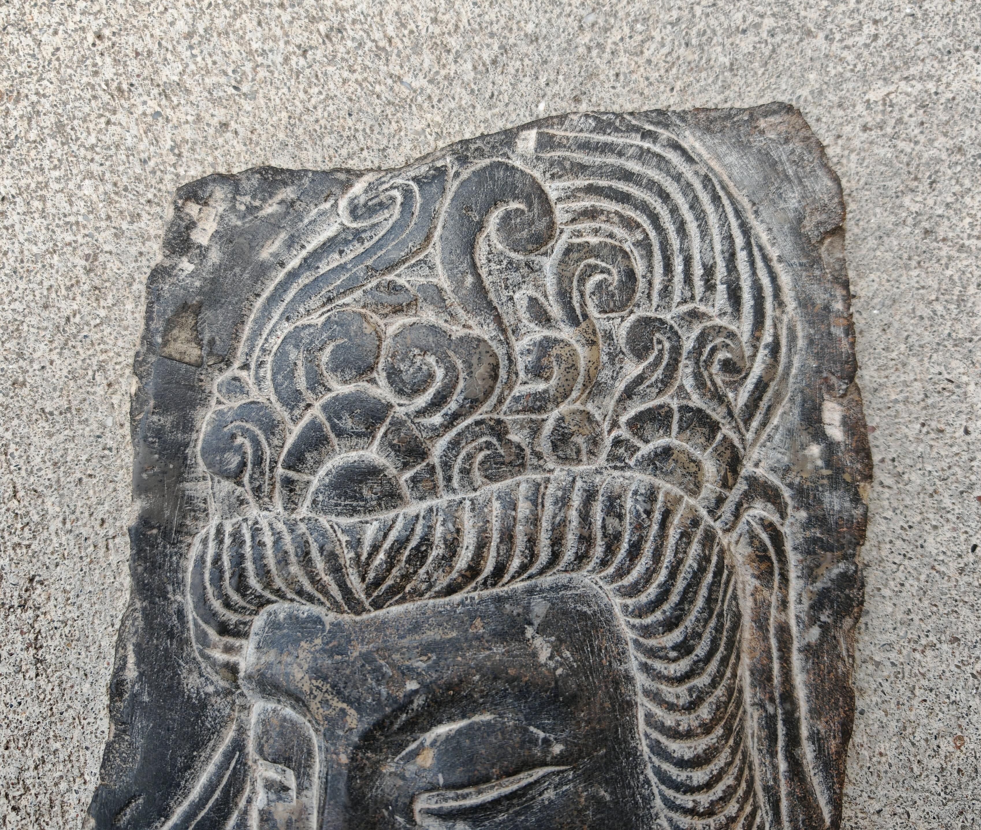 Antique portrait of Buddha hand-carved in stone, 19th century.