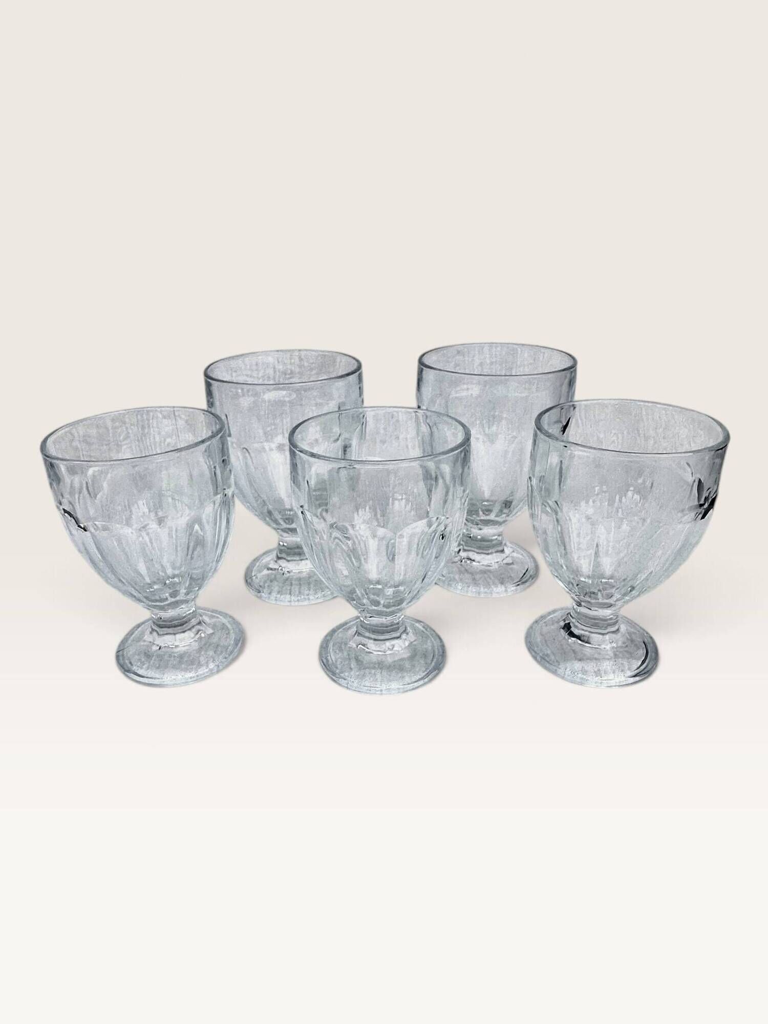 Set of 5 stemmed glasses made of pressed moulded glass.
