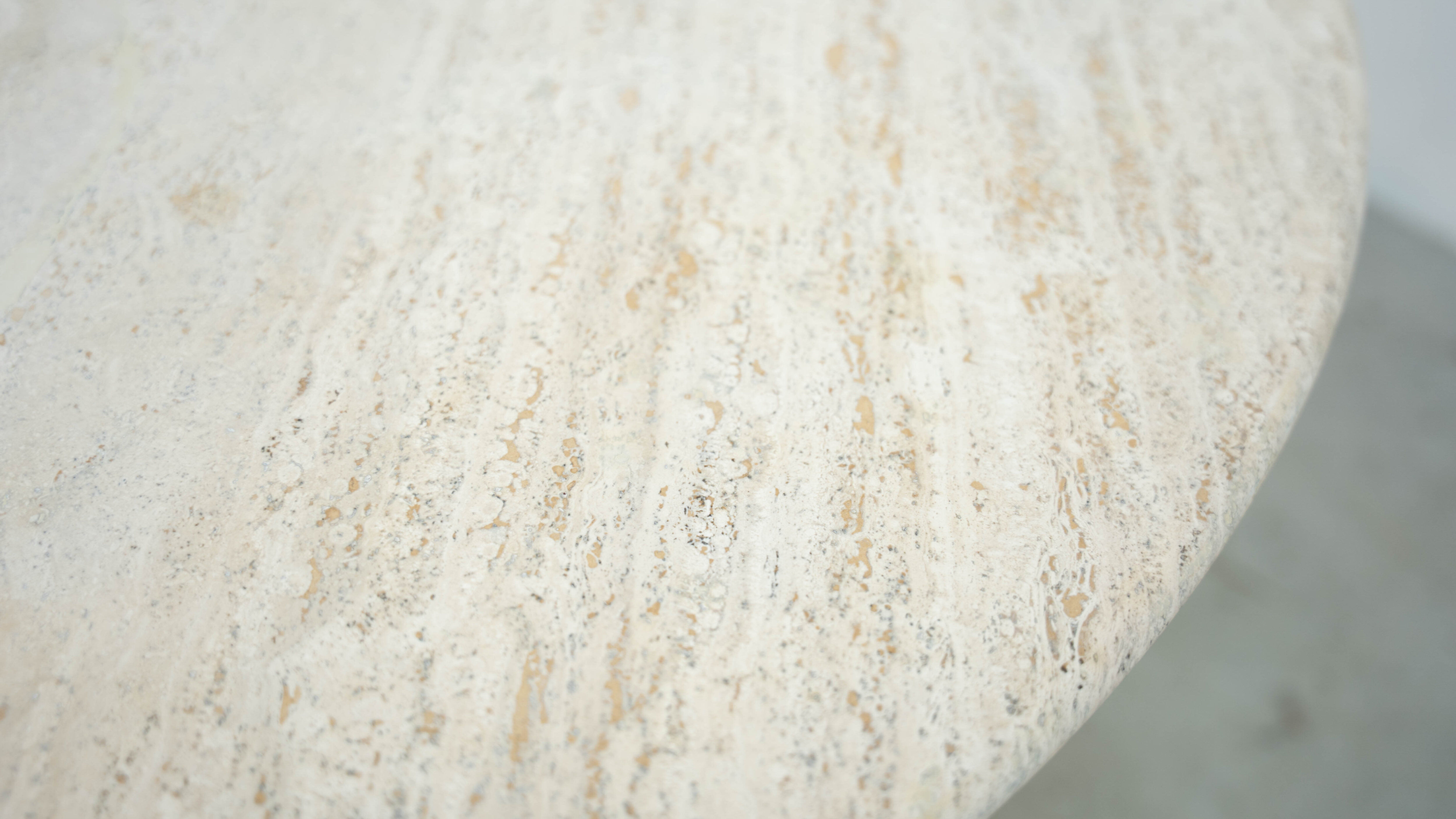 Round Belgian travertine dining table