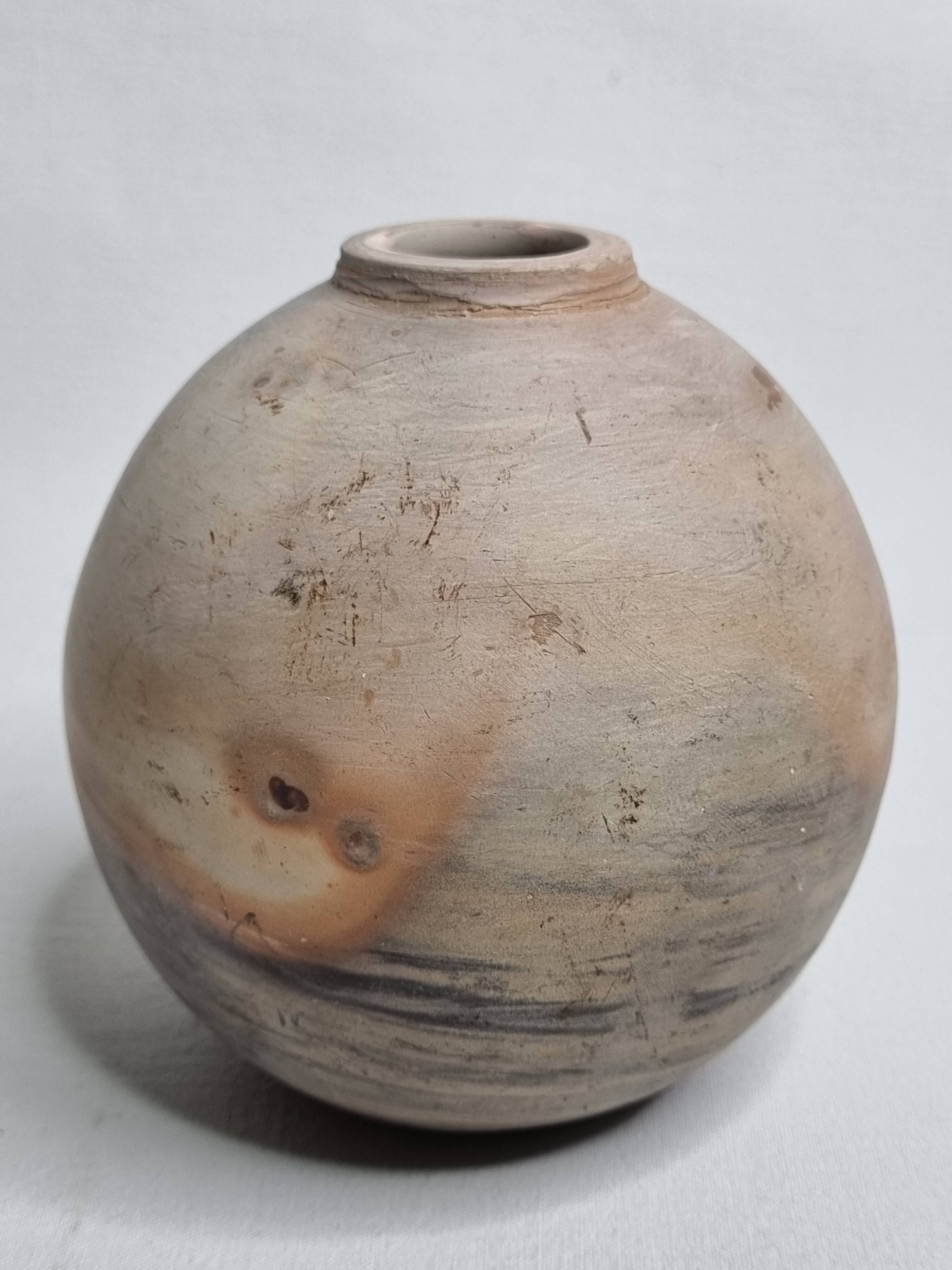Round ceramic vase with raw finish, smoked firing, signed, late 20th century, 11 cm.