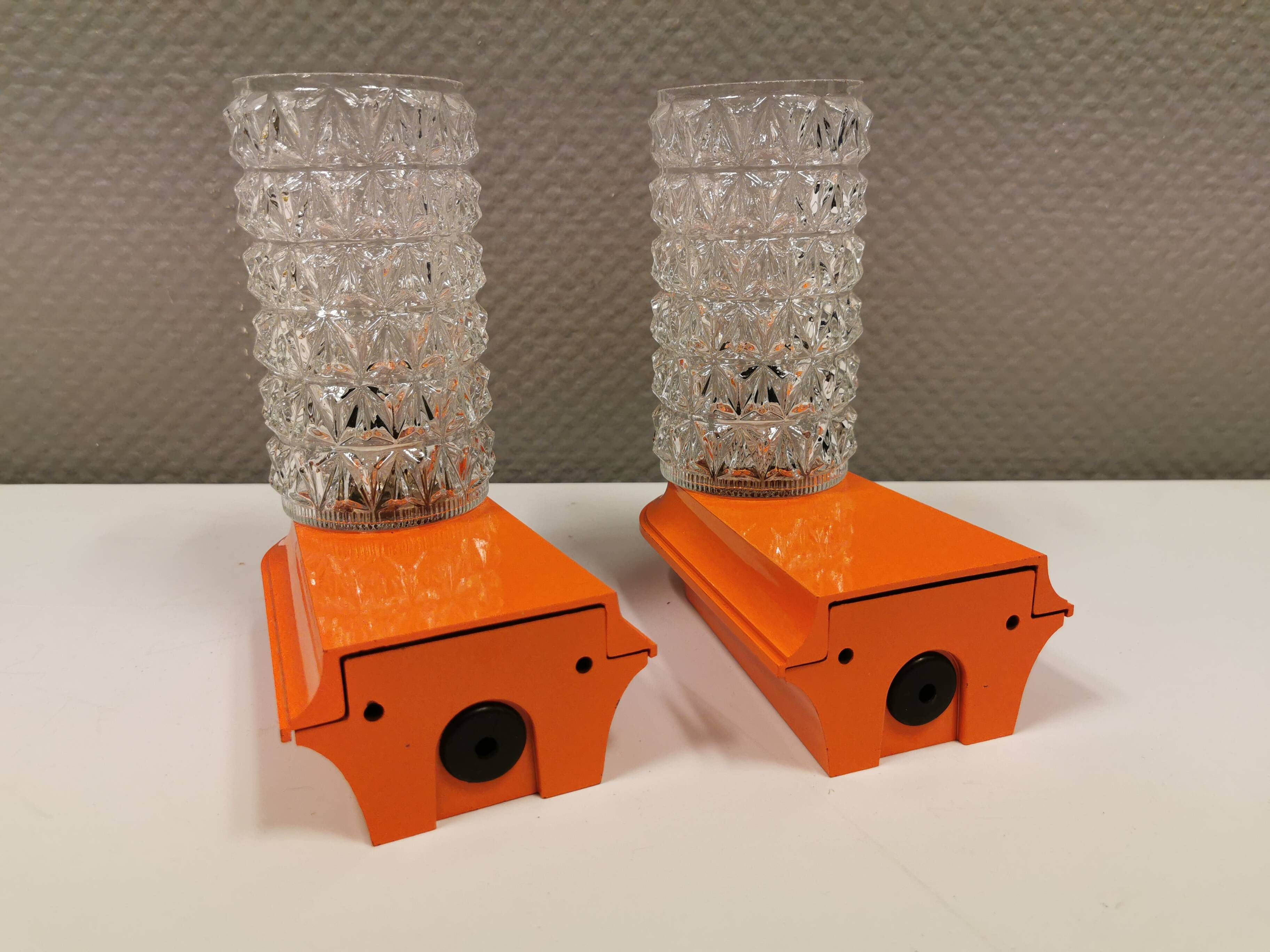 Bathroom lamps in a nice orange colour with a crystal glass shade and a base of hard thin plastic