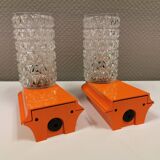 Bathroom lamps in a nice orange colour with a crystal glass shade and a base of hard thin plastic