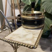 Gold wrought iron ashtray on legs with magazine rack and marbled shelf