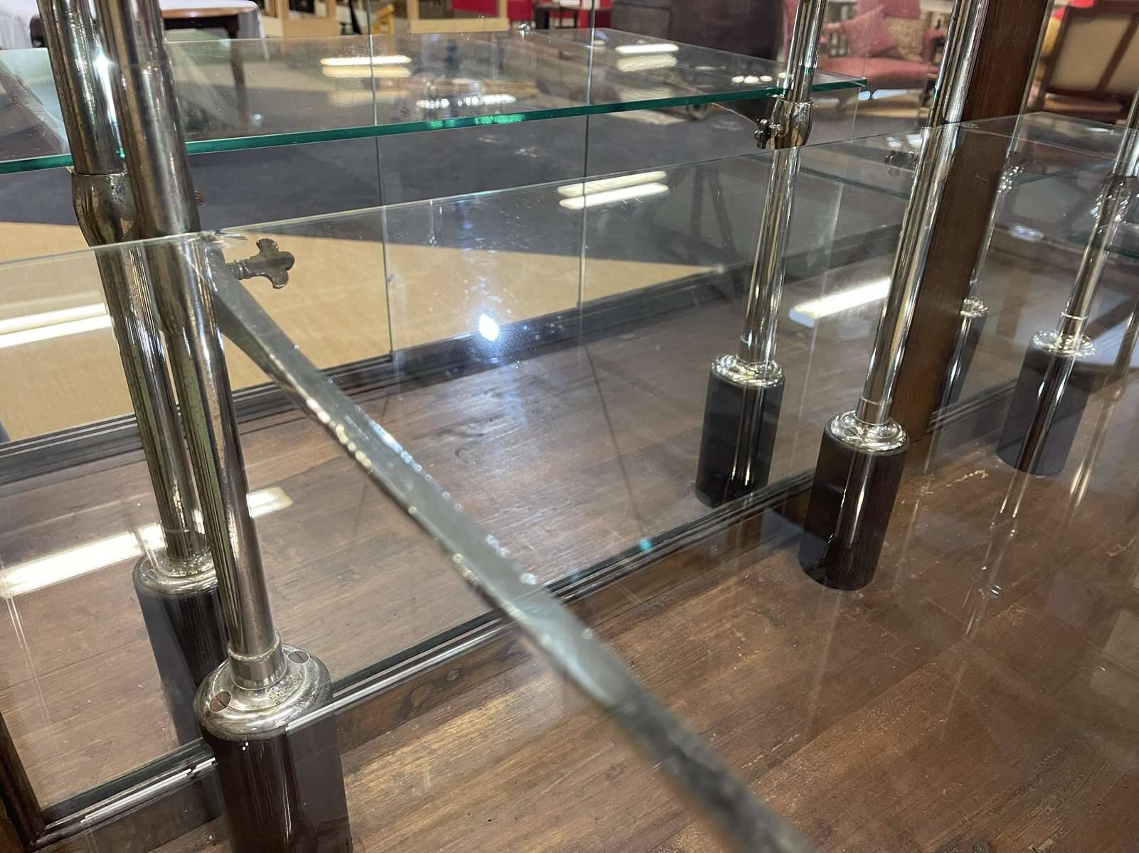 Early 20th-century shop display cabinet in oak with sliding doors.