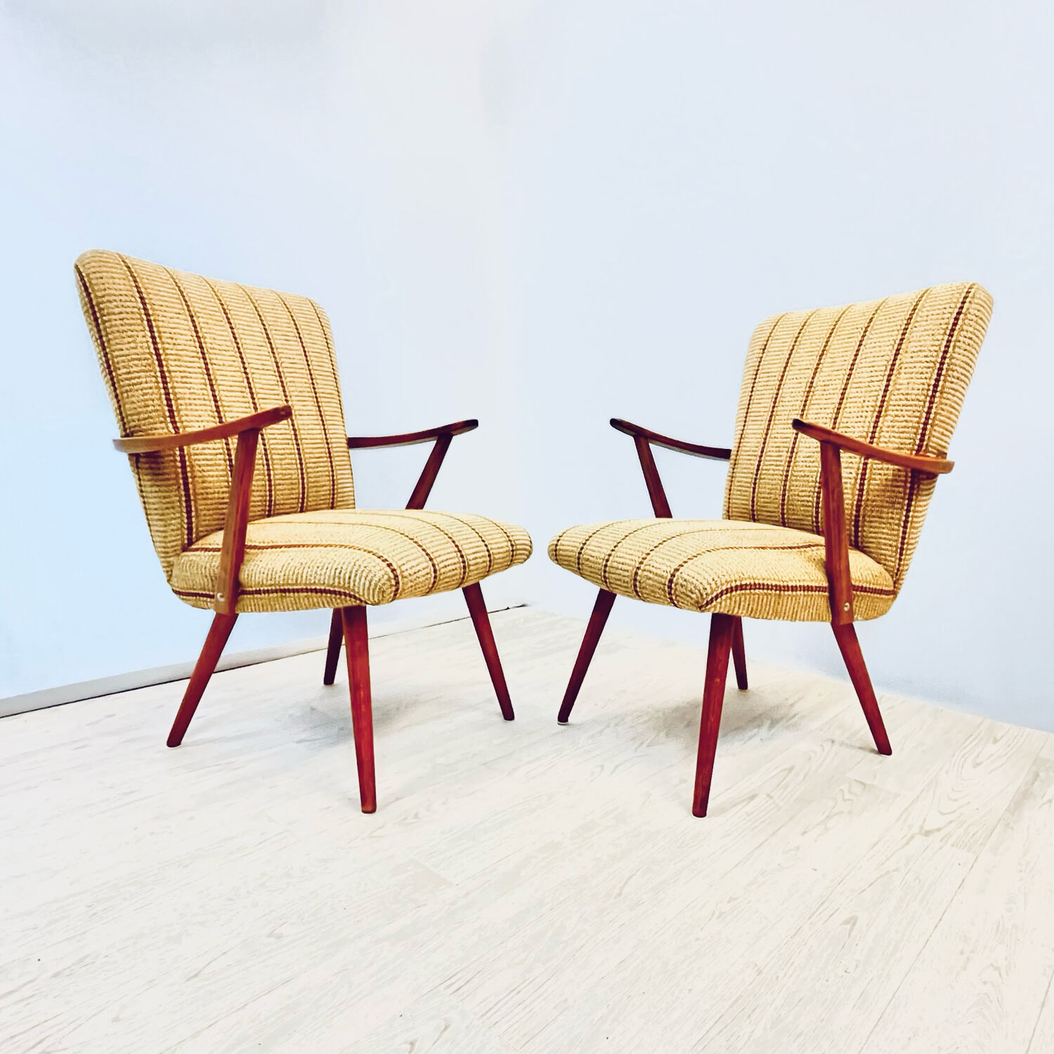 A pair vintage cocktail chairs with stripes and metal screws