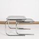 Pair of nesting tables in smoked glass and chrome legs.