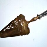 Antique silver-plated pie server with a brass blade decorated with roses.