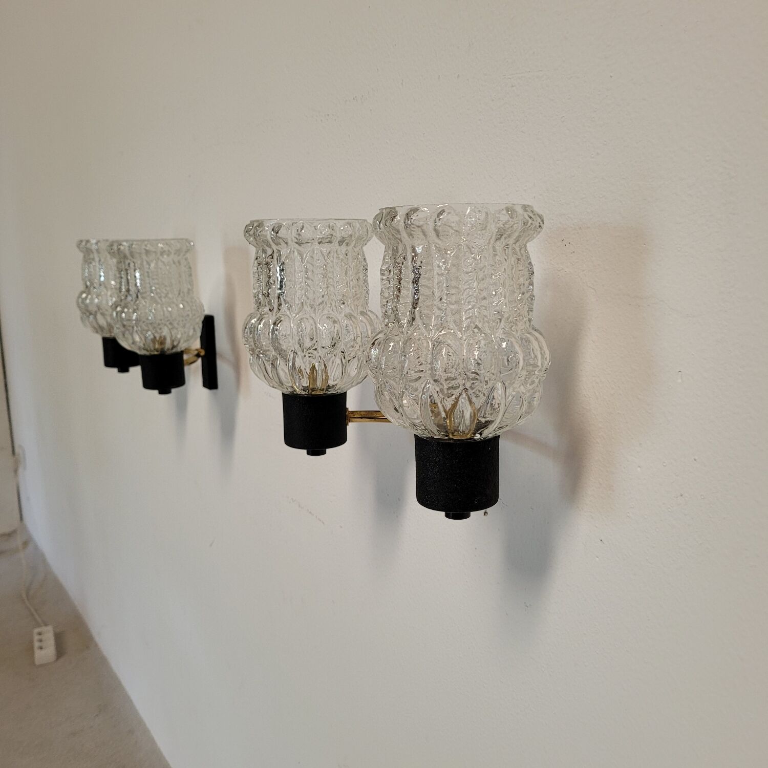 Vintage Arlus wall lights in glass and brass from the 1970s.