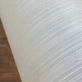 Gold metal wall light with ribbed glass.