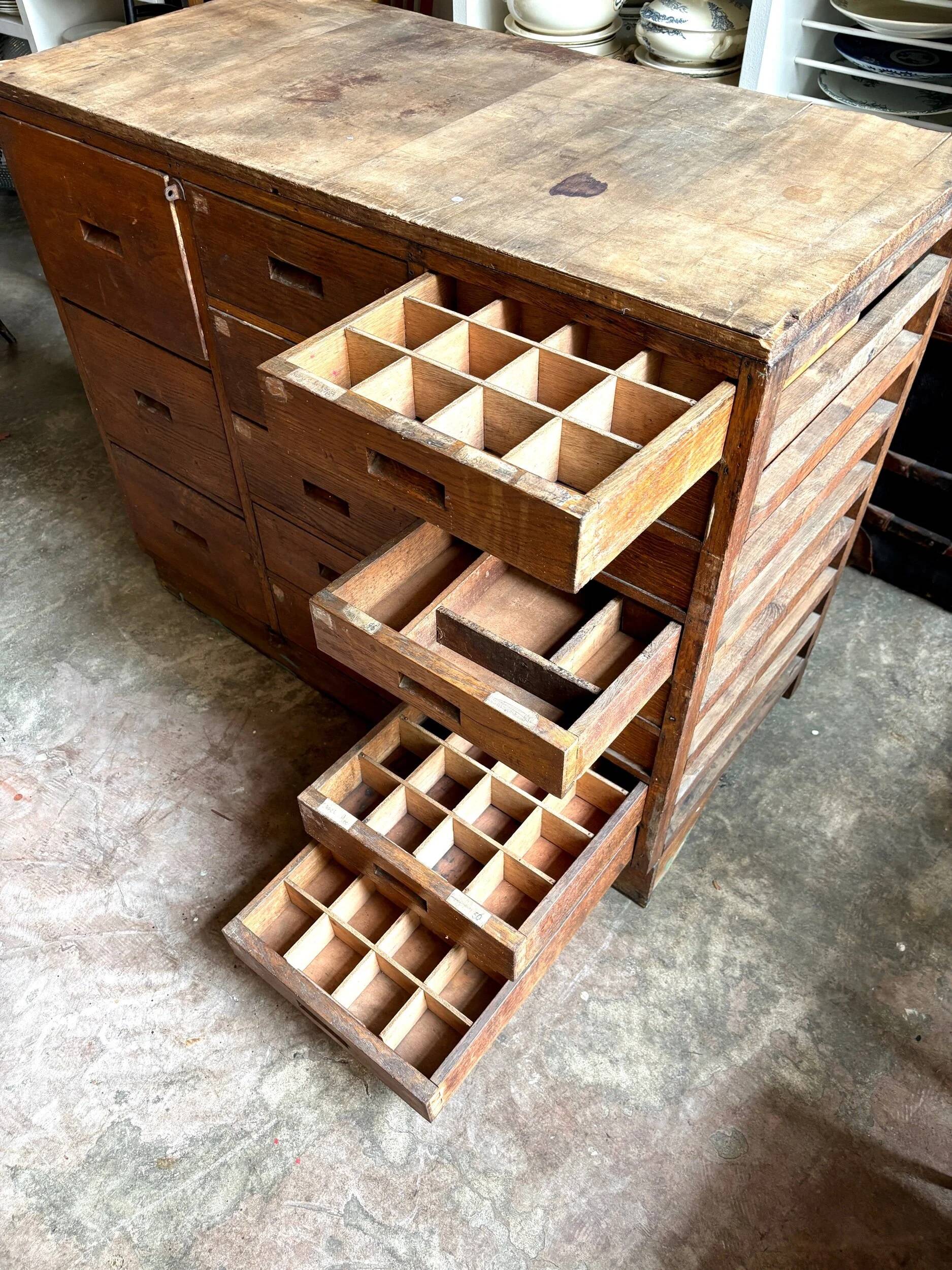 Craftsman's cabinet with 16 drawers in dark wood.