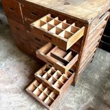 Craftsman's cabinet with 16 drawers in dark wood.