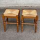 2 square stools made of carved solid wood with rush seats from the 1970s.