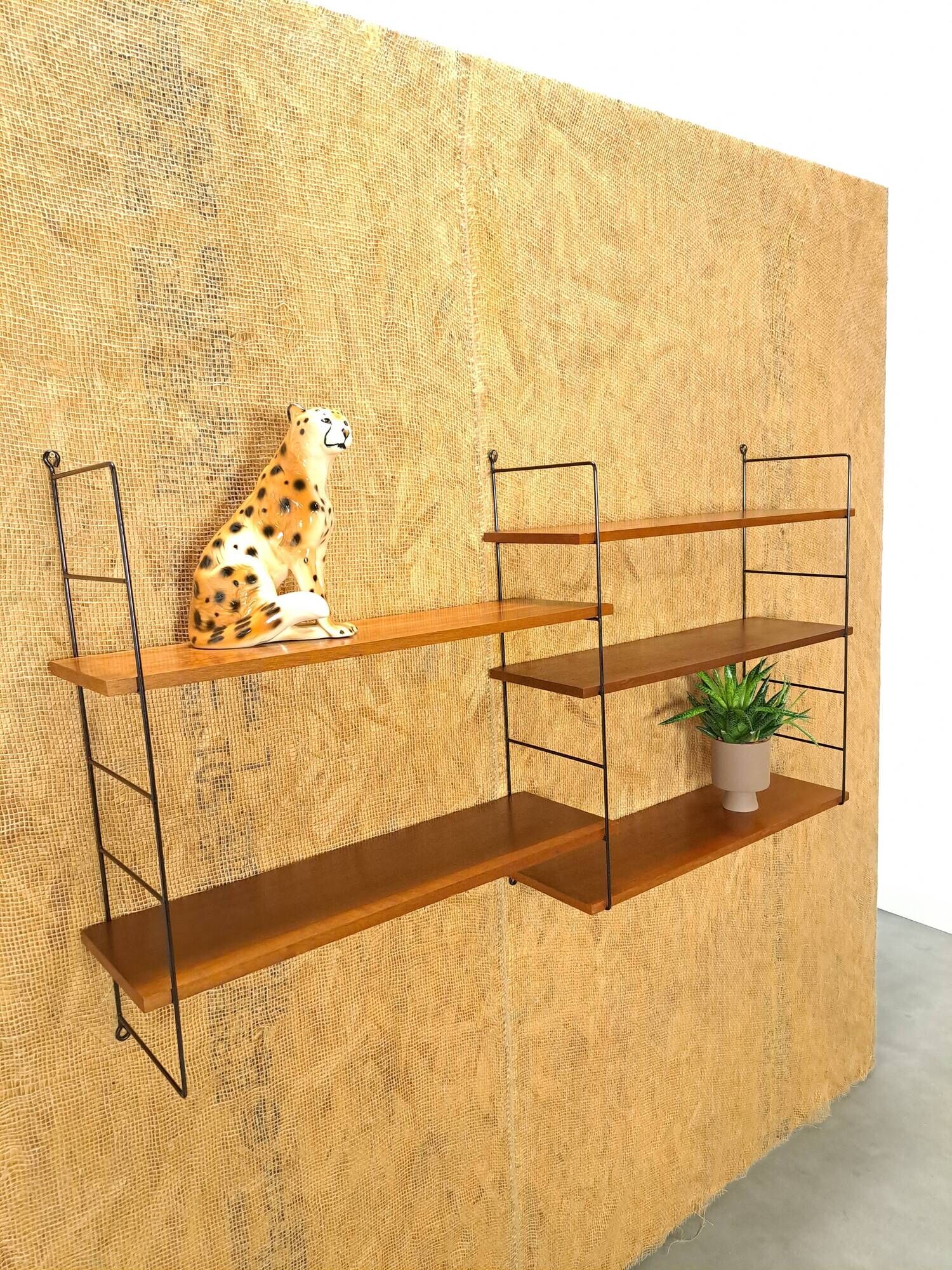 Wall rack with shelves and steel holders, dark wall system