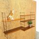 Wall rack with shelves and steel holders, dark wall system