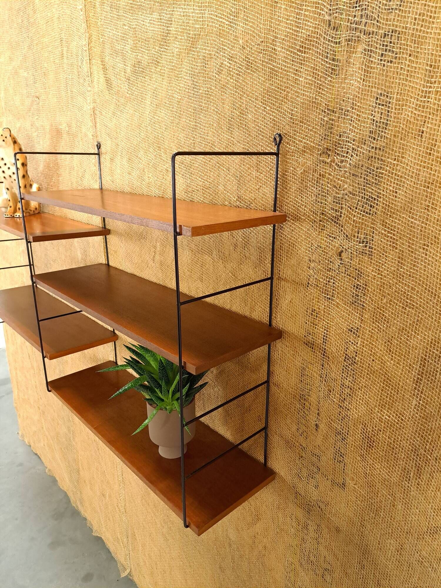 Wall rack with shelves and steel holders, dark wall system