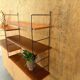 Wall rack with shelves and steel holders, dark wall system