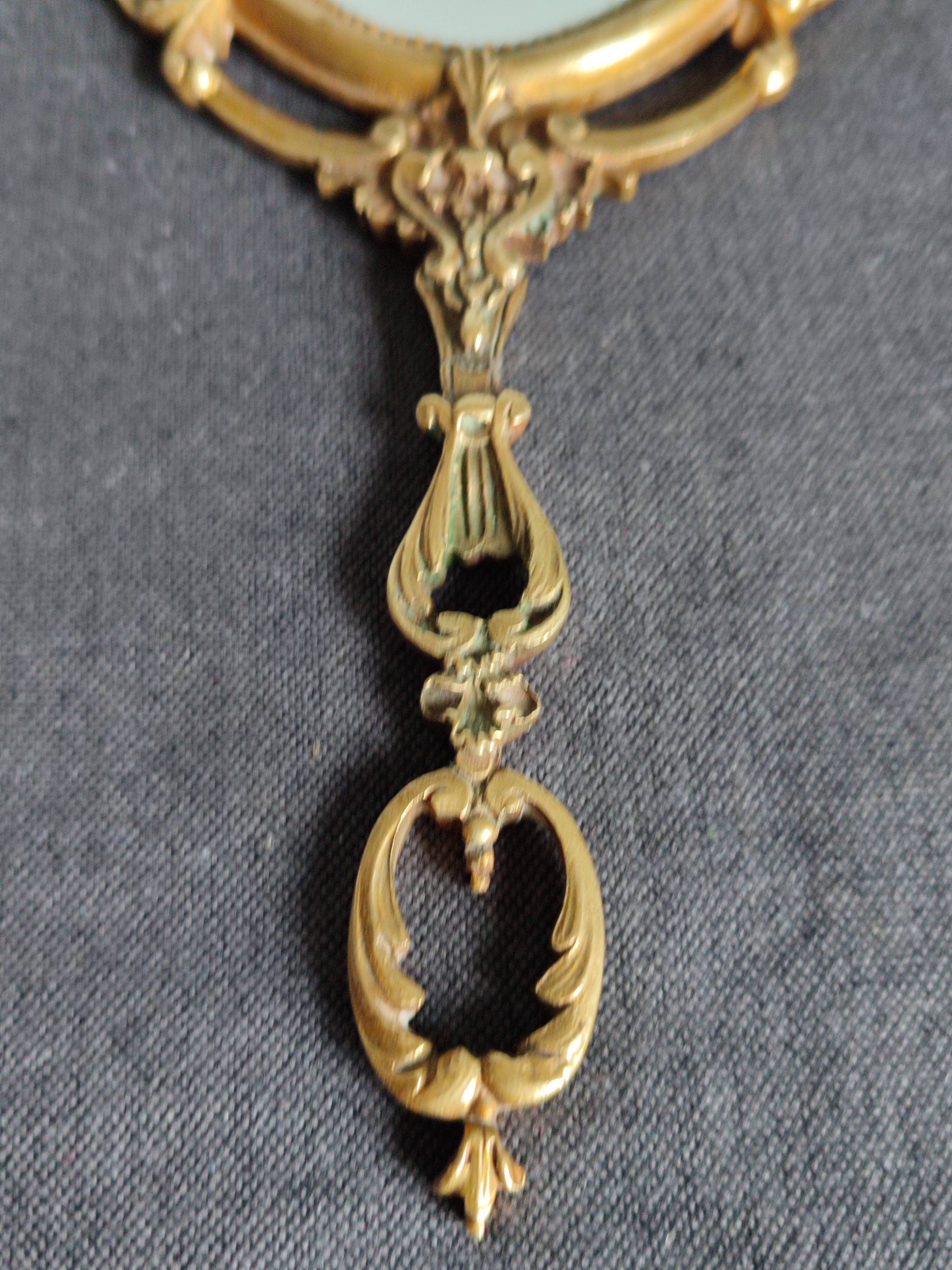 Antique hand-facing mirror in bronze and beveled glass