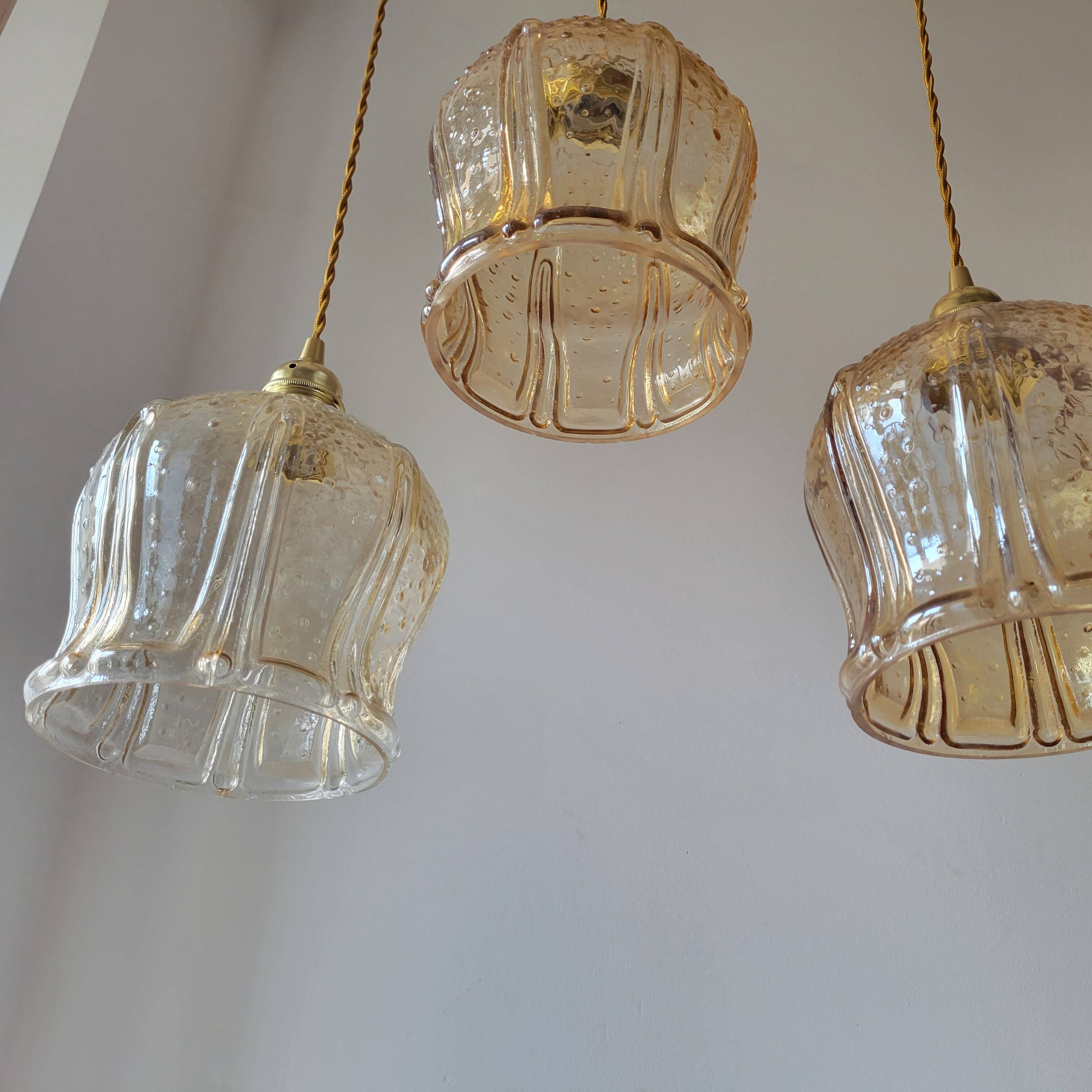 Trio of amber glass pendant lights
