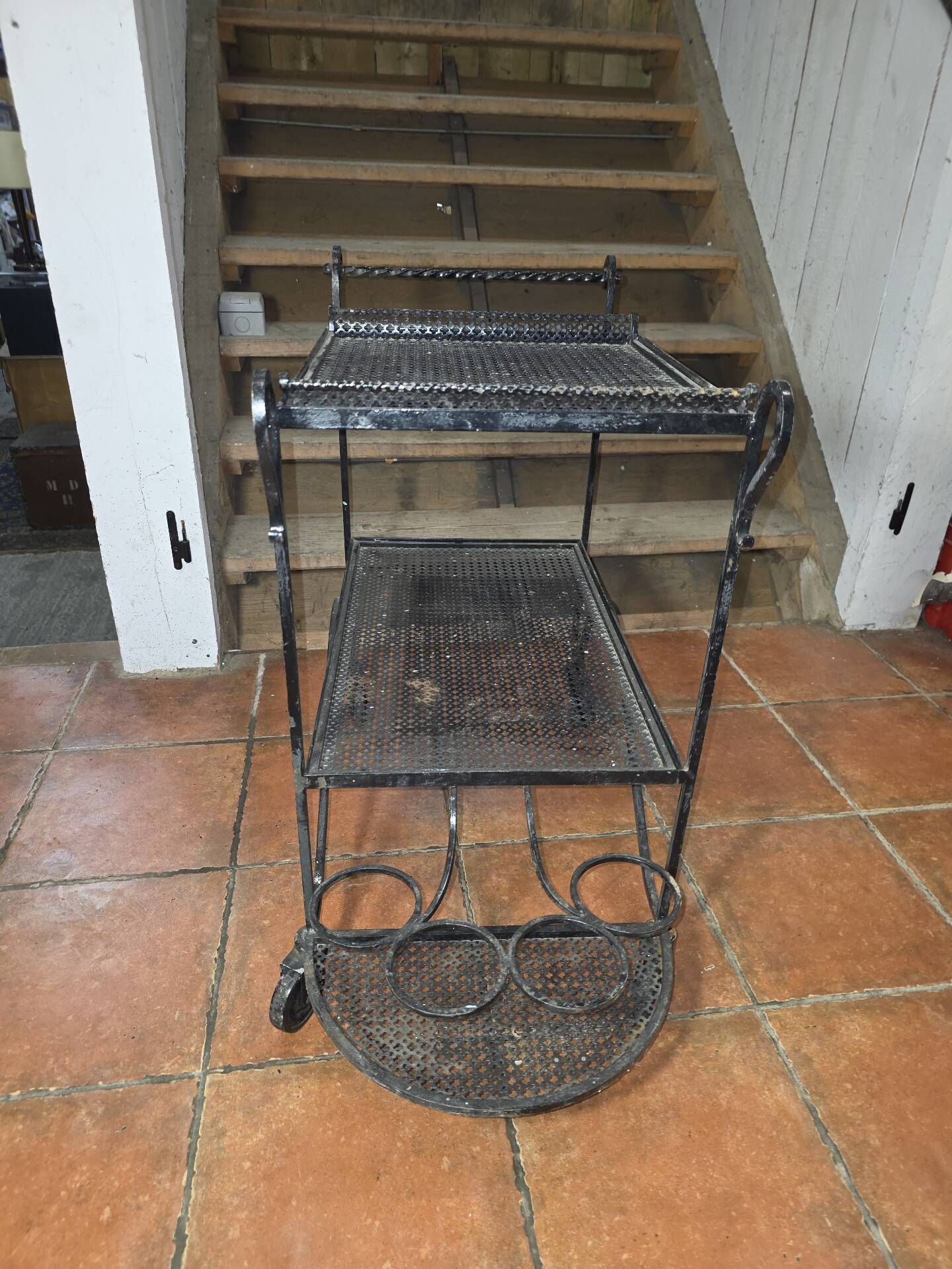 Perforated wrought iron rolling dessert trolley