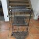 Perforated wrought iron rolling dessert trolley