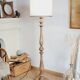 Vintage floor lamp in turned wood with an aged effect.