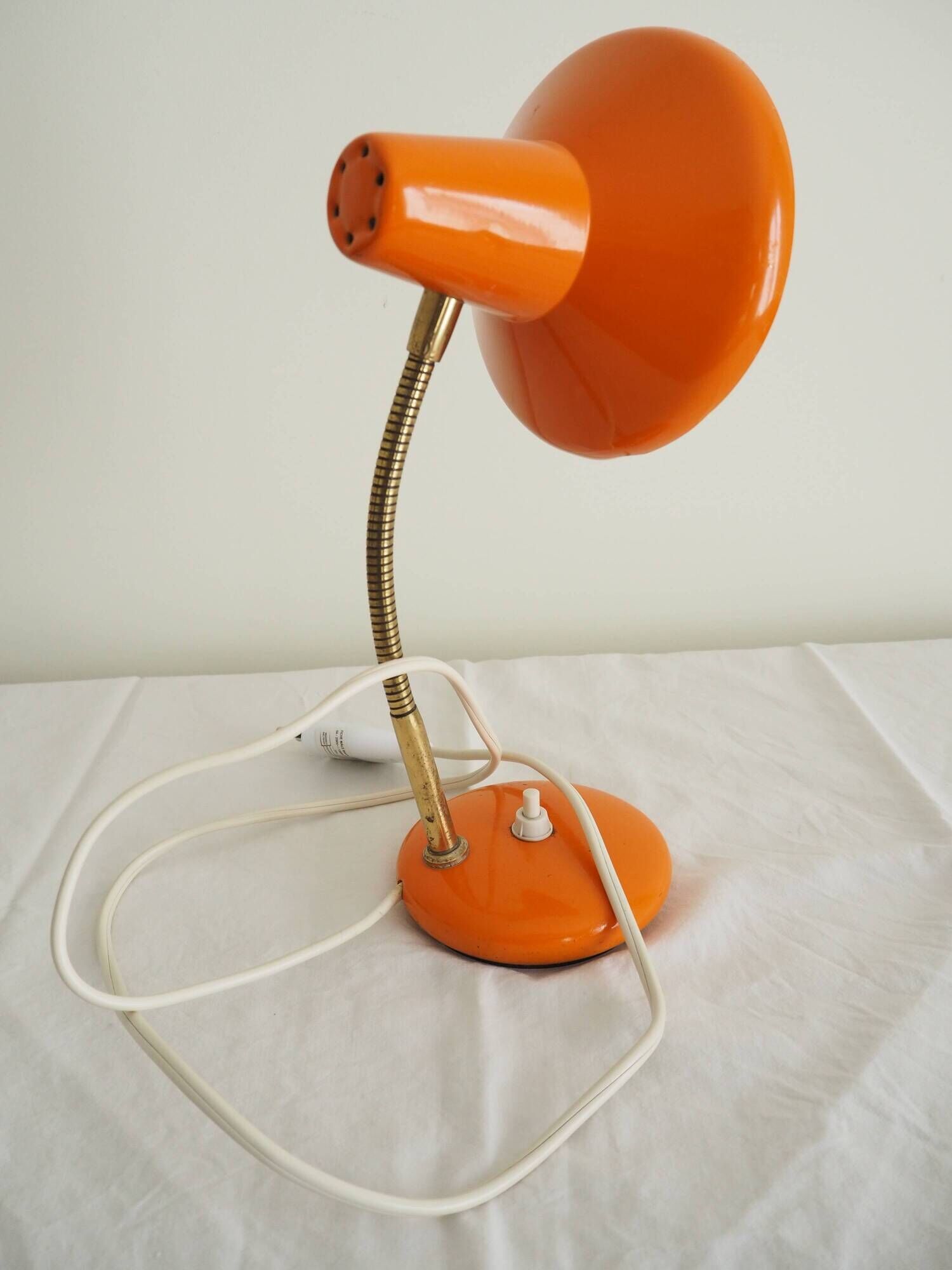 Orange colored metal desk lamp from the 1960s-1970s