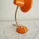 Orange colored metal desk lamp from the 1960s-1970s
