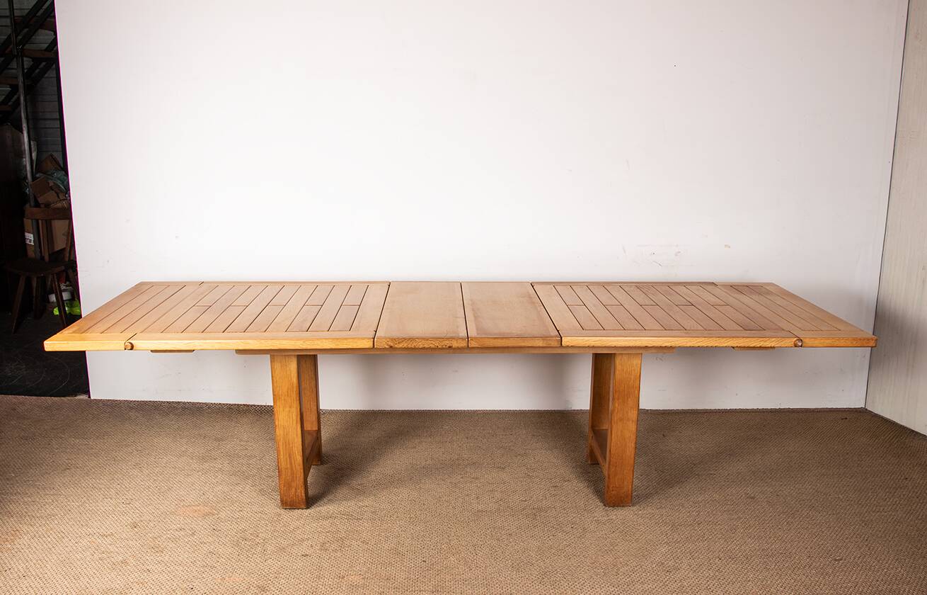 Large extendable dining table in solid oak by Guillerme and Chambron.