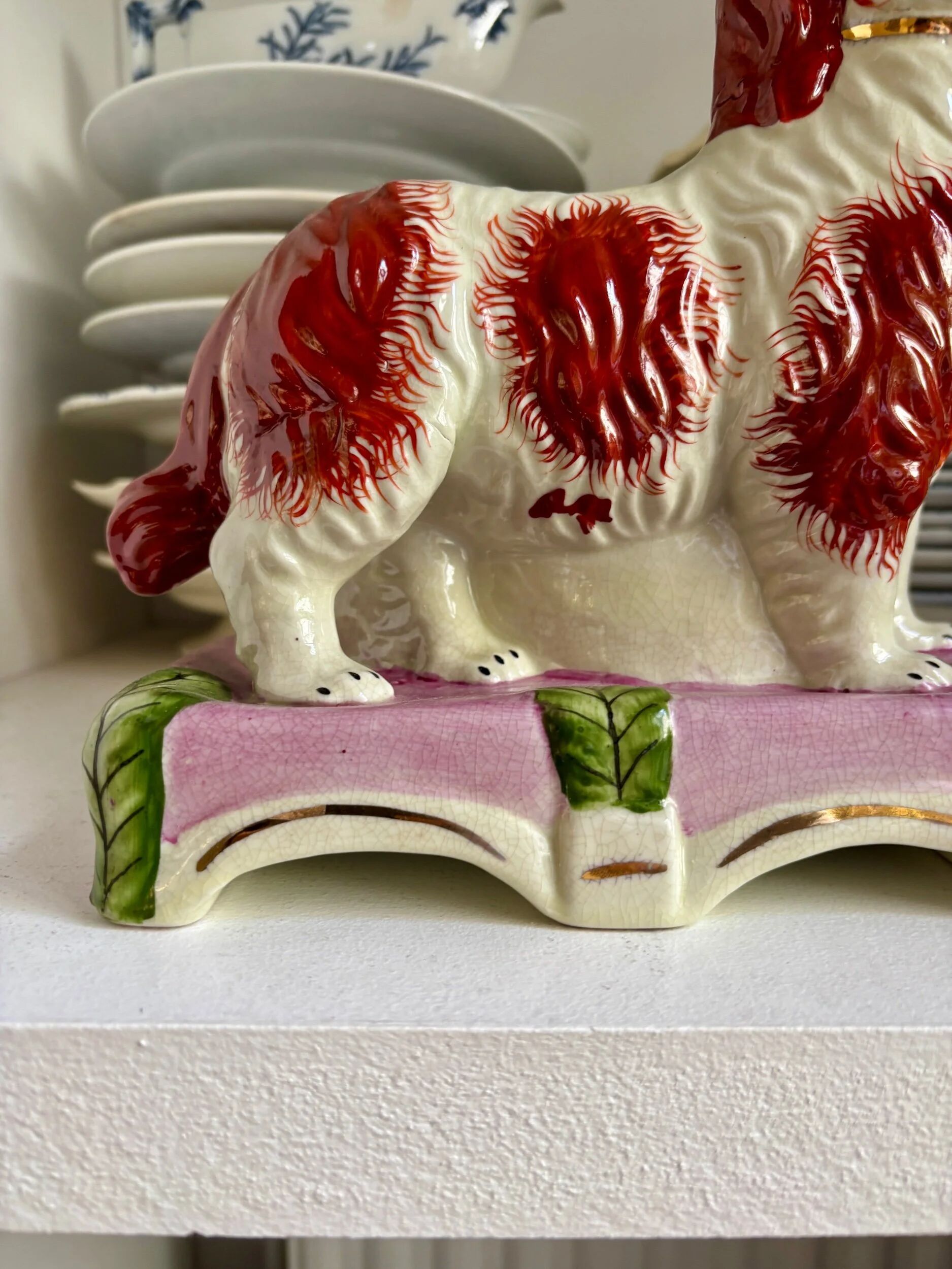 Pair of Staffordshire porcelain Cavalier King Charles dogs on terrace, 19th century.