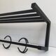Designer coat rack in blackened metal
