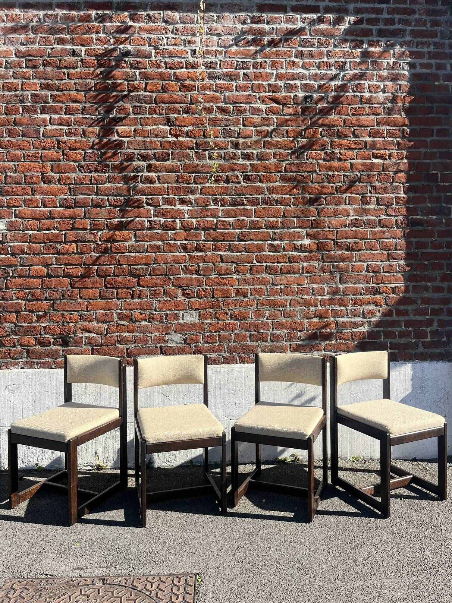 Many mid-century vintage wooden and fabric chairs.