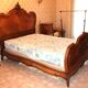 Walnut rocaille bed from the early 20th century.