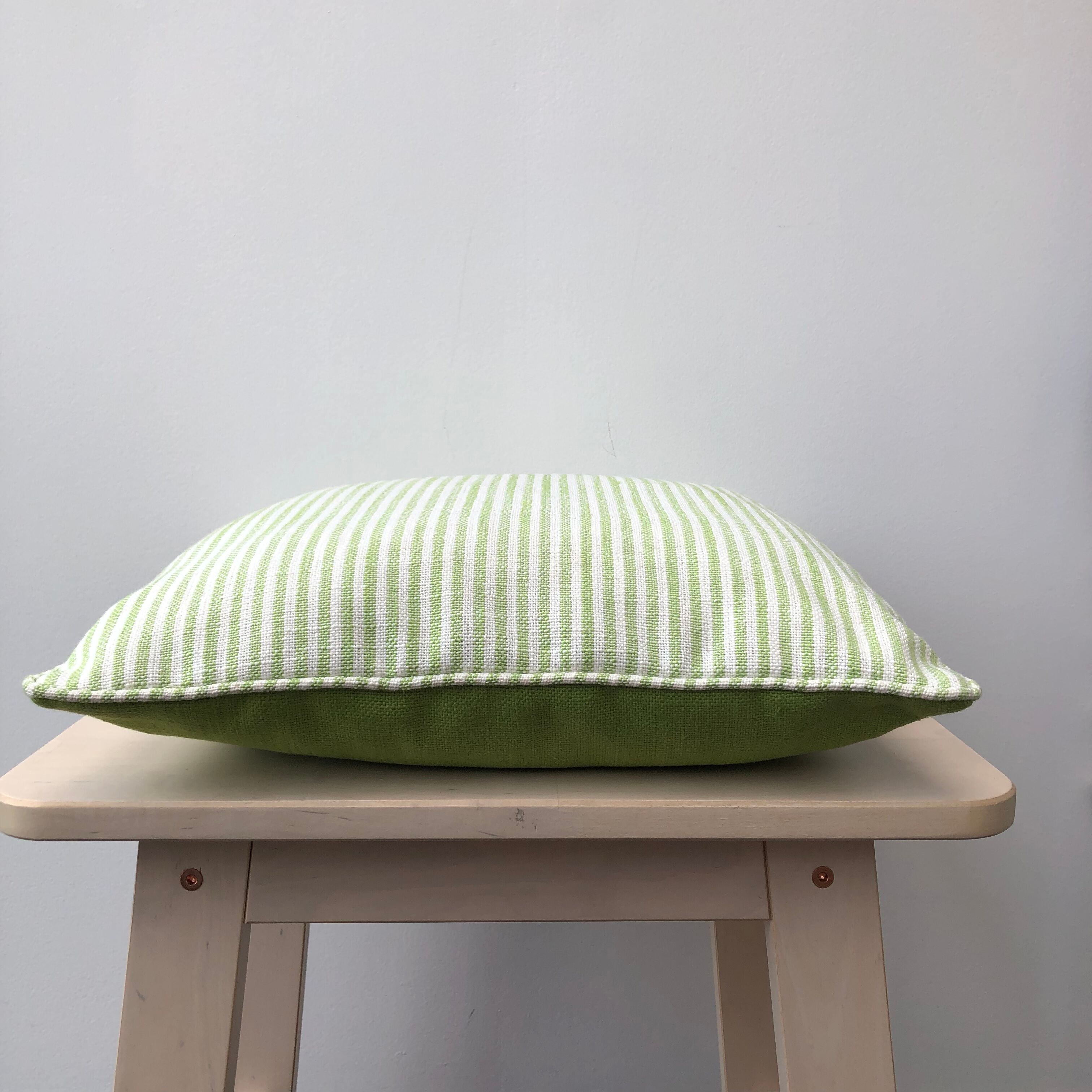 Green and white striped cushion