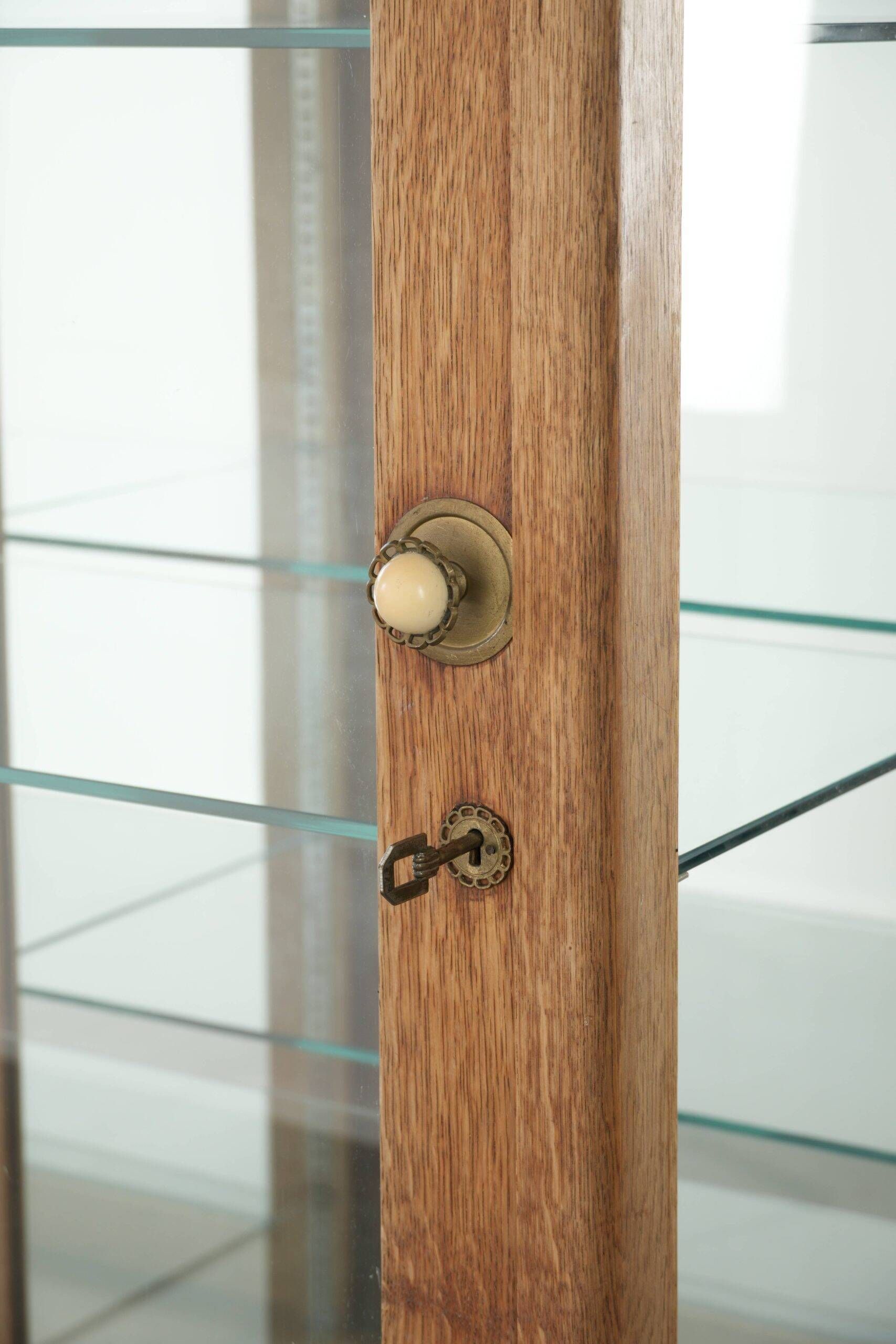 Antique Dutch oak display cabinet with glass shelves and a mirrored back