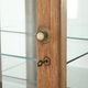 Antique Dutch oak display cabinet with glass shelves and a mirrored back