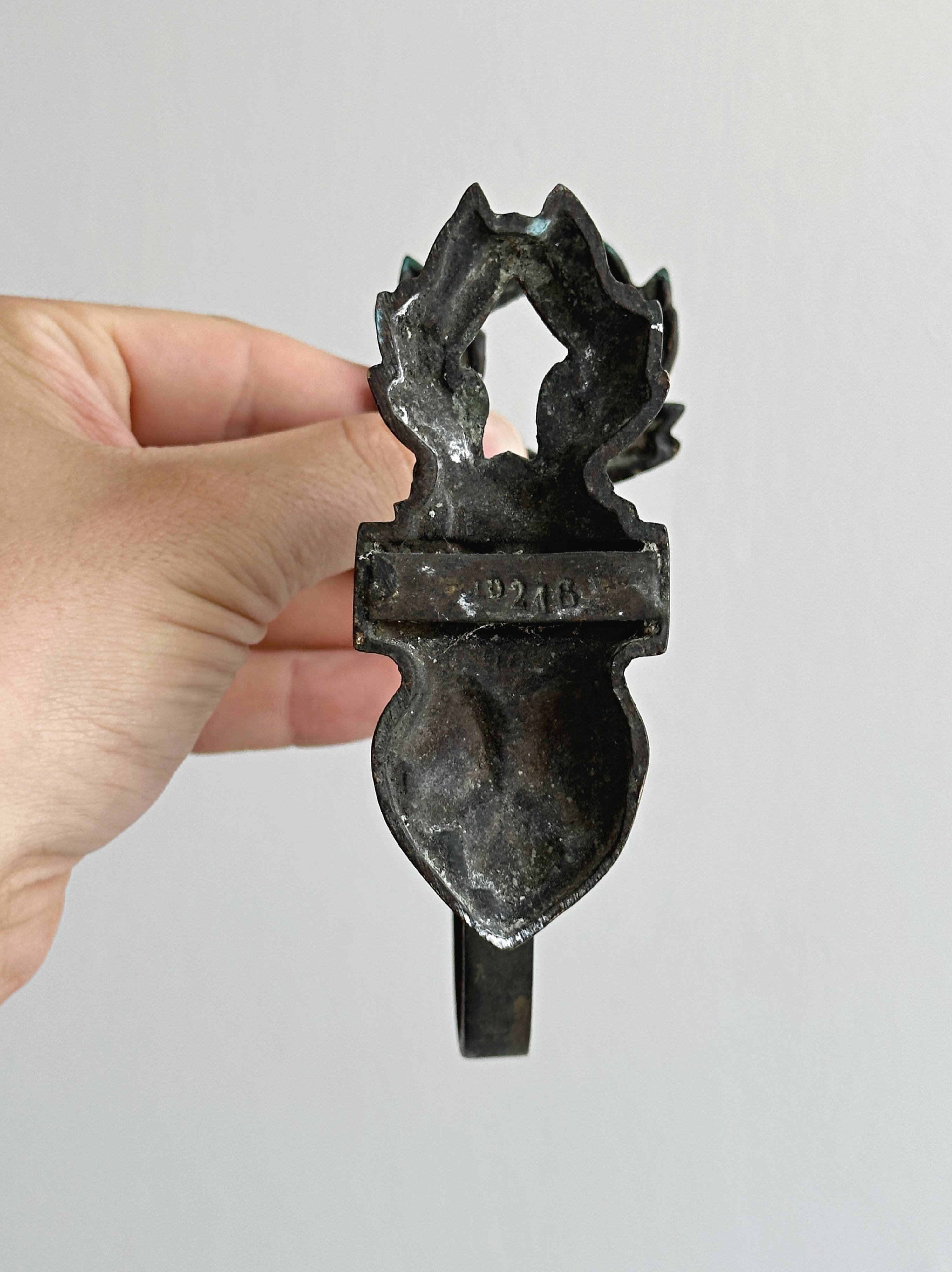 Antique black patinated metal coat hook.