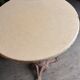 Cast iron base side table with a stone-effect top.