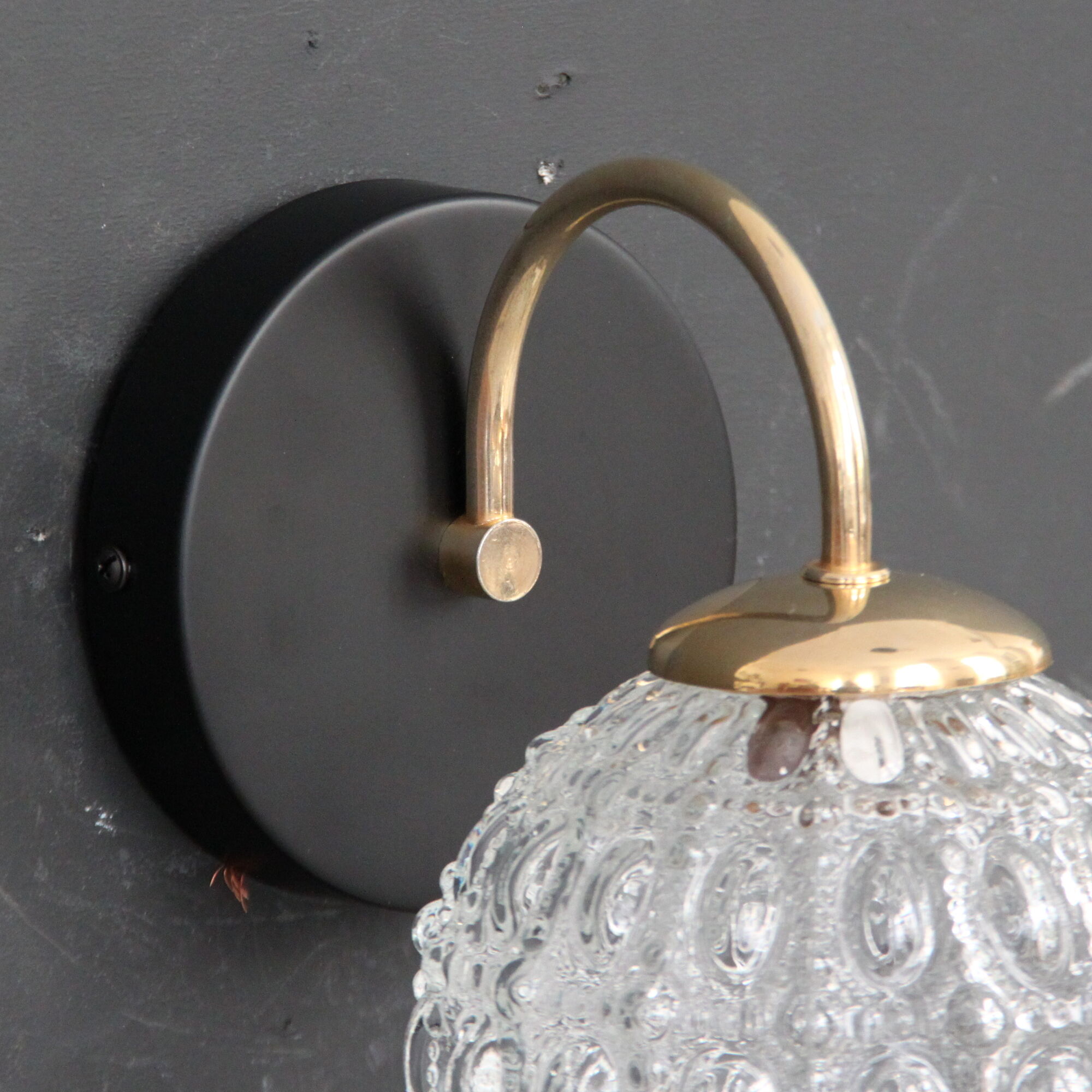 Globe wall light in moulded glass, brass swan collar, circa 1950