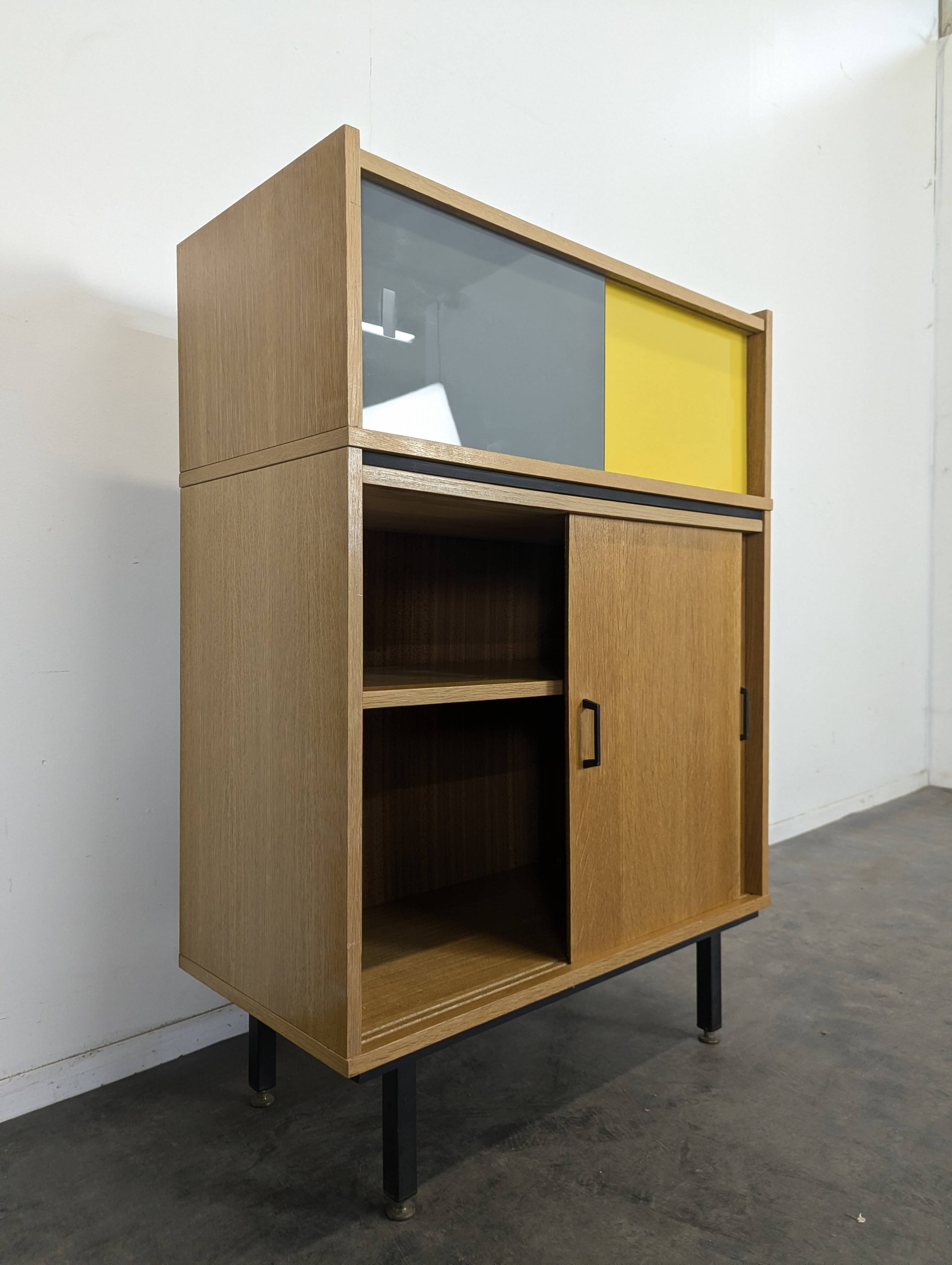 Modernist sideboard with glass doors in grey and yellow oak veneer.