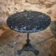 Old French bistro table with a marble top and a cast iron base.