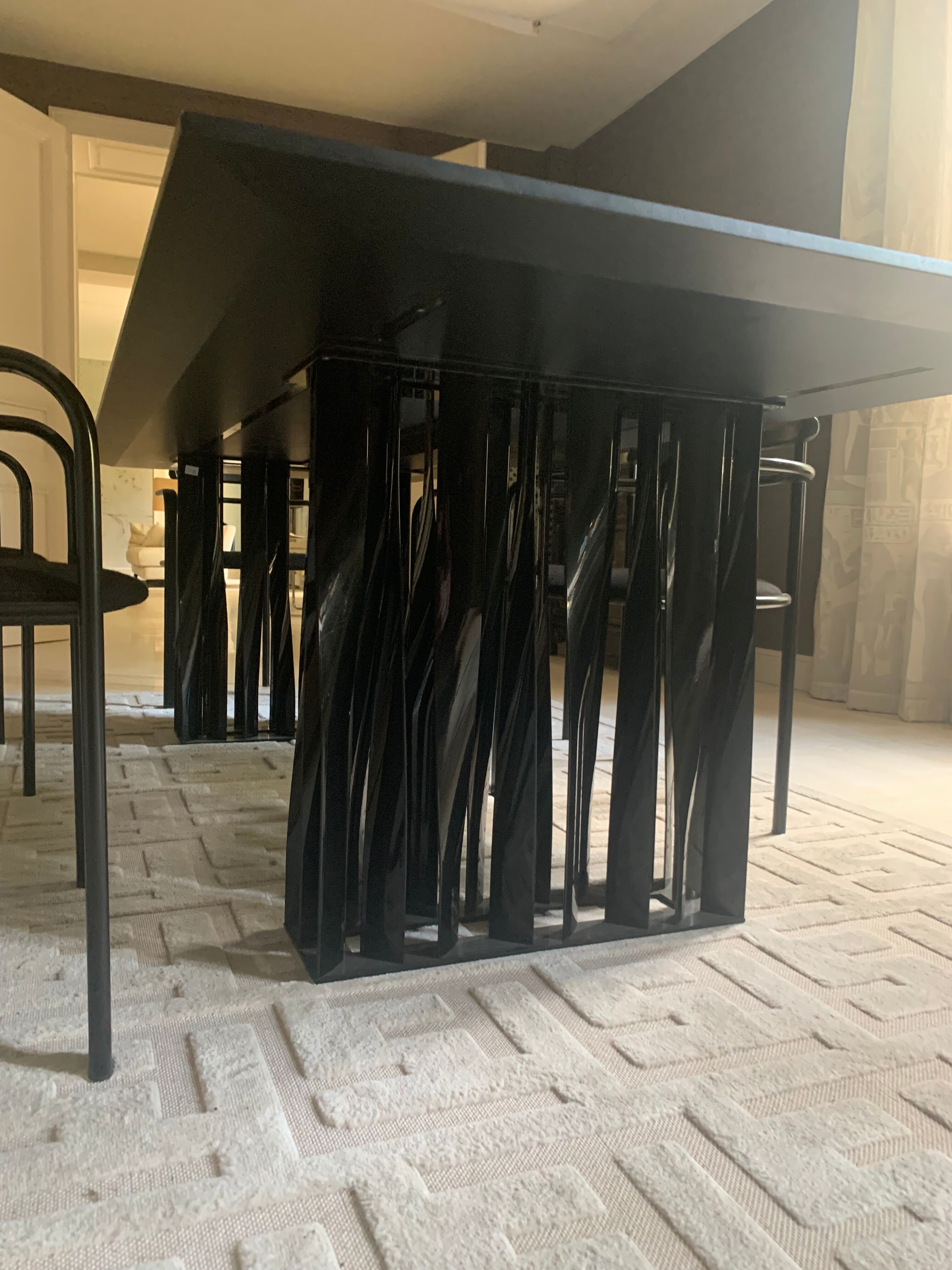 Black dining room table, wooden, rectangle with upholstered chairs.