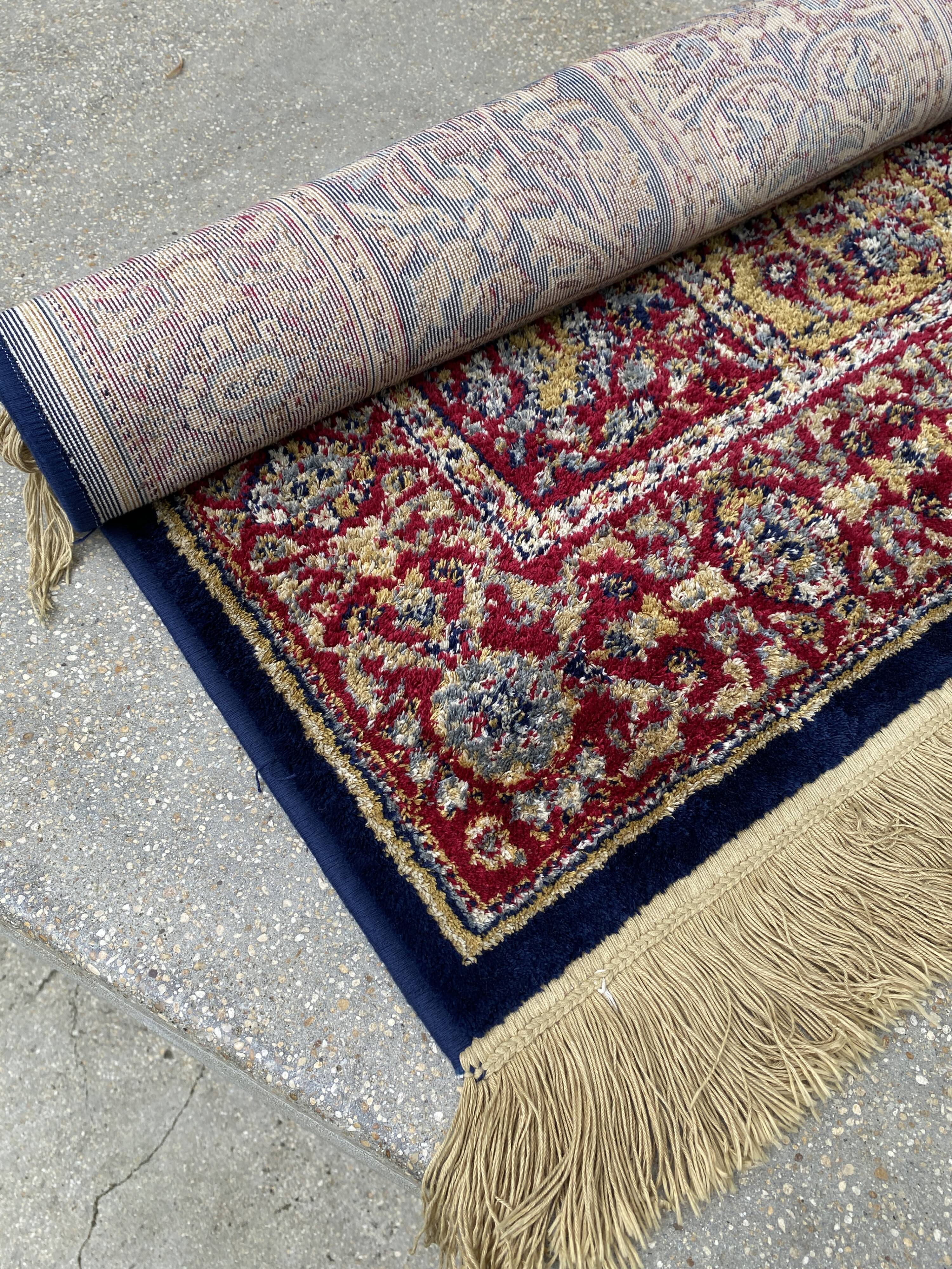 Vintage mechanical Turkish rug with box decoration on a red and navy blue background 139 x 68 cm