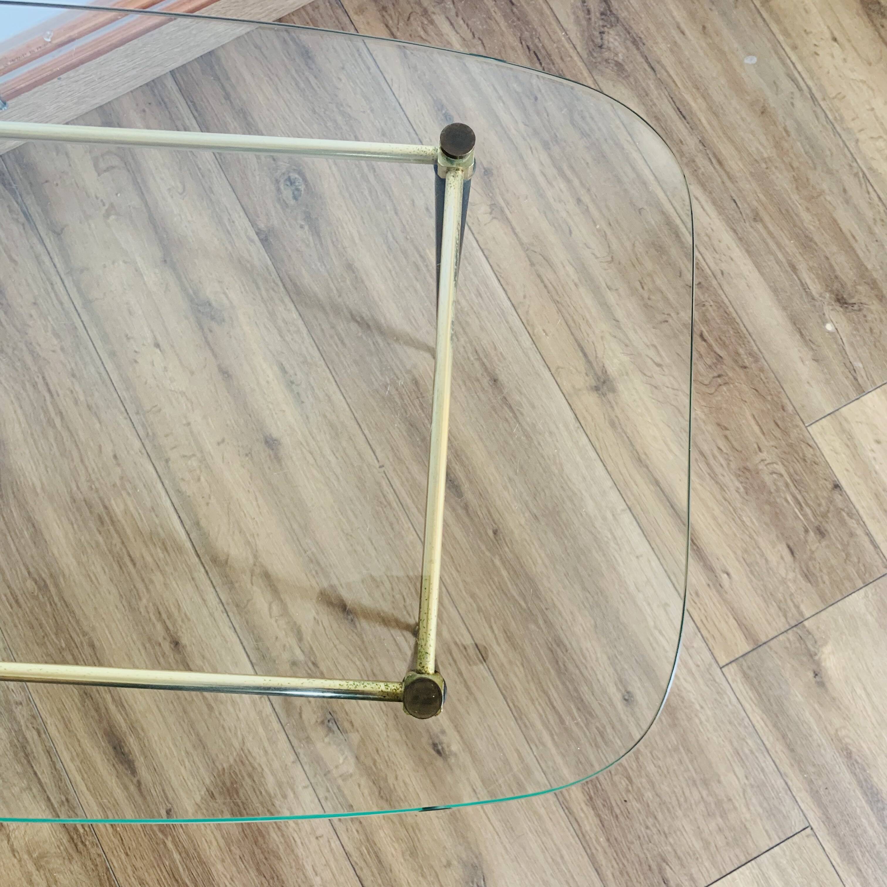 Coffee table from the 50s/60s, glass, brass, black metal.