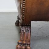 Characteristic antique sheepskin leather armchair with beautiful details and a unique design