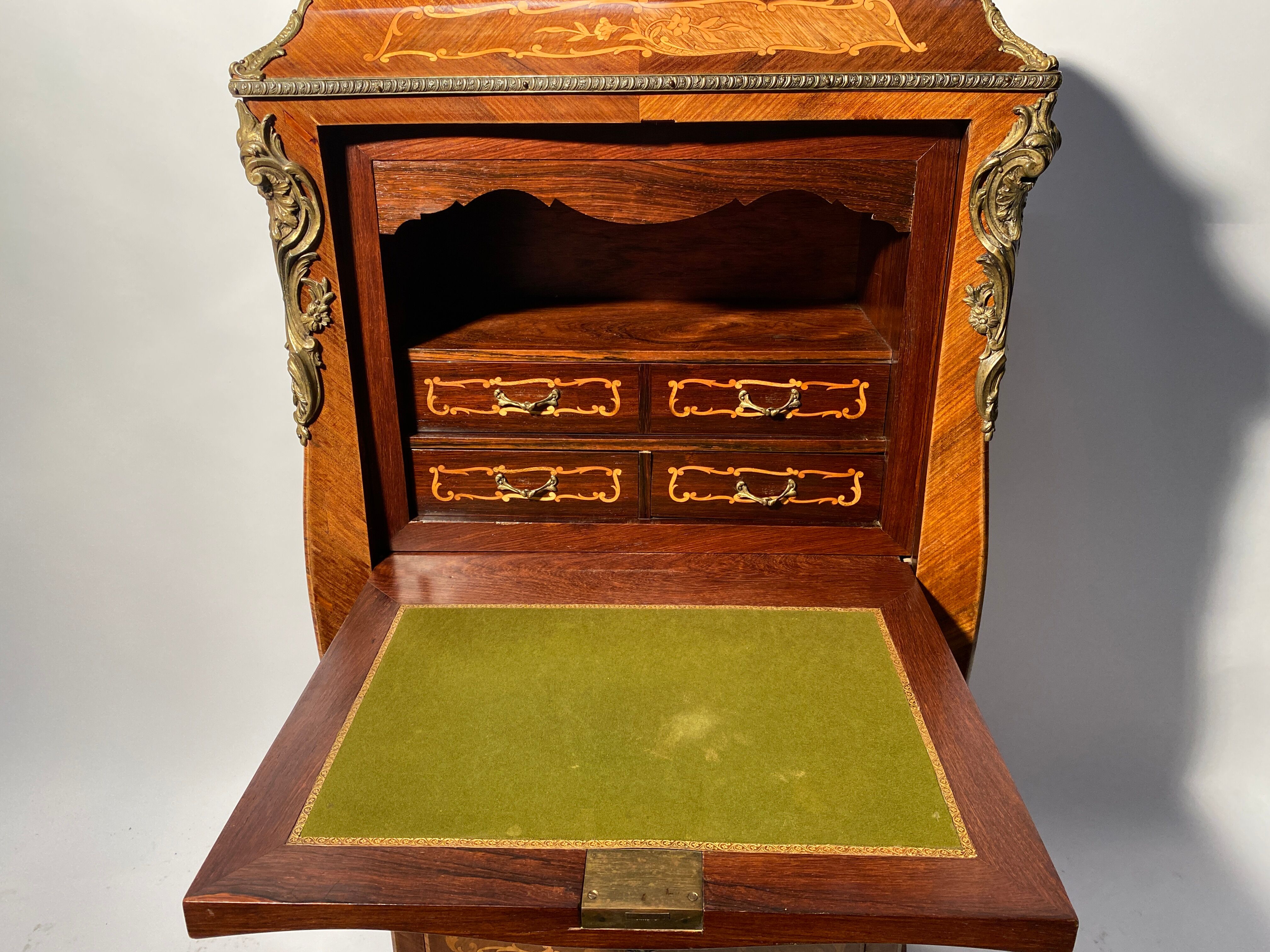 Curved secretary and inlaid with floral branches in Louis XV style