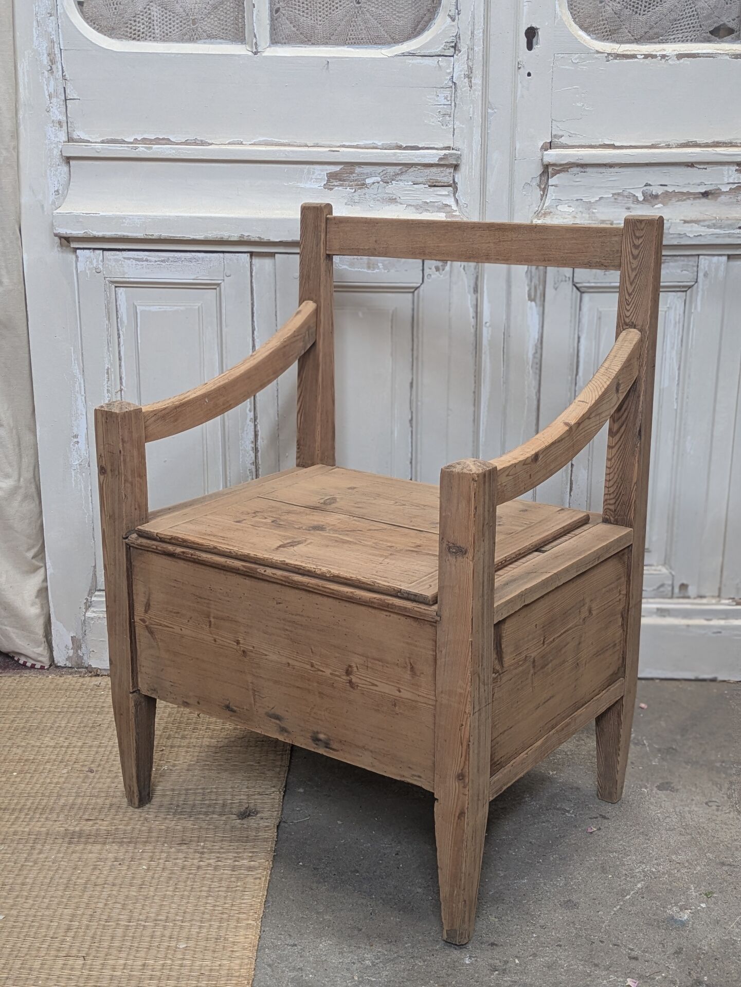 Antique armchair in raw wood