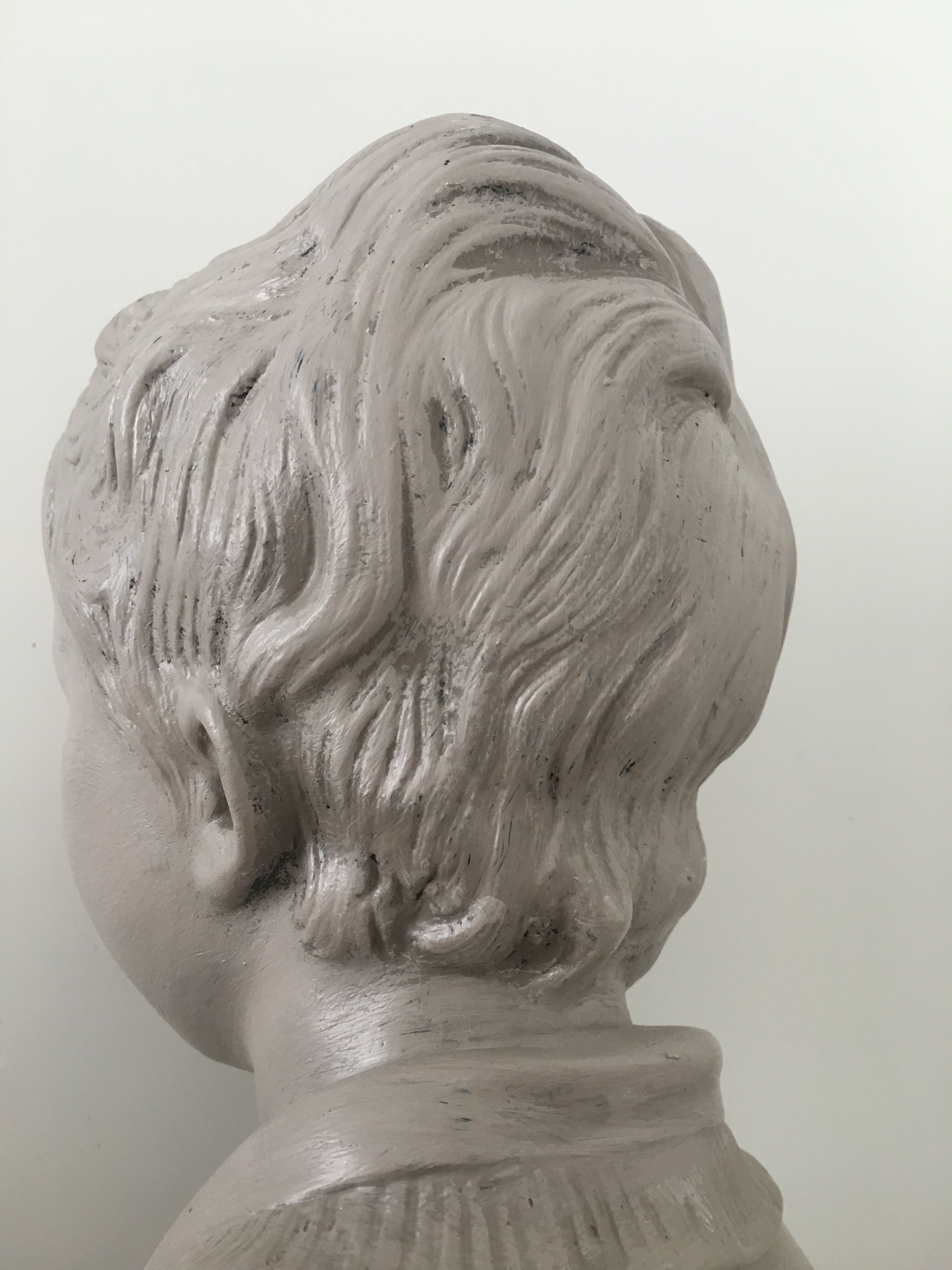 Cherub bust in platter