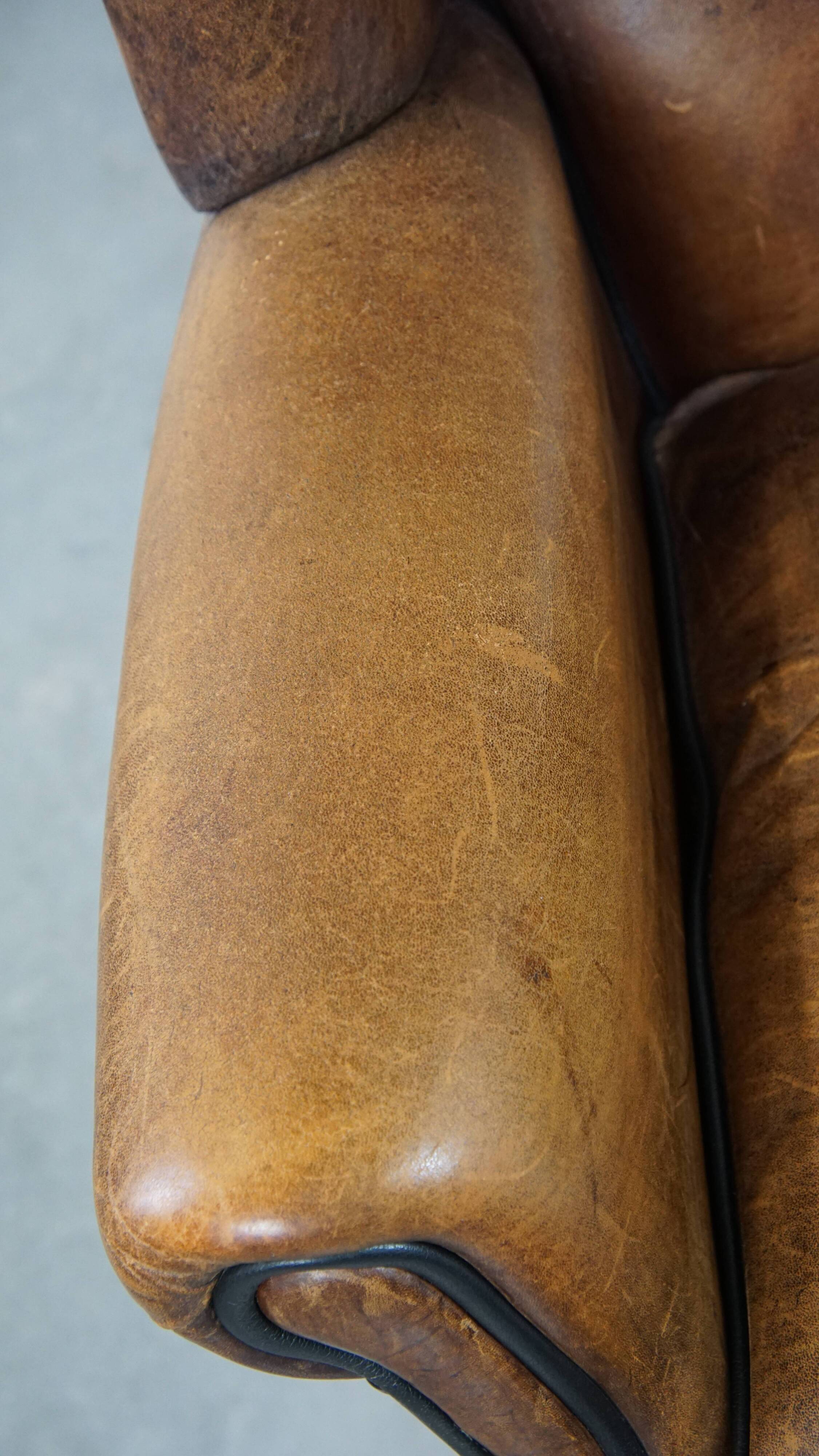 Sheep leather wingback chair finished with black piping